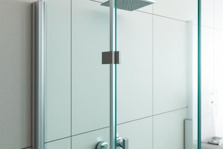 A crystal-clear frameless shower screen in a tiled bathroom.